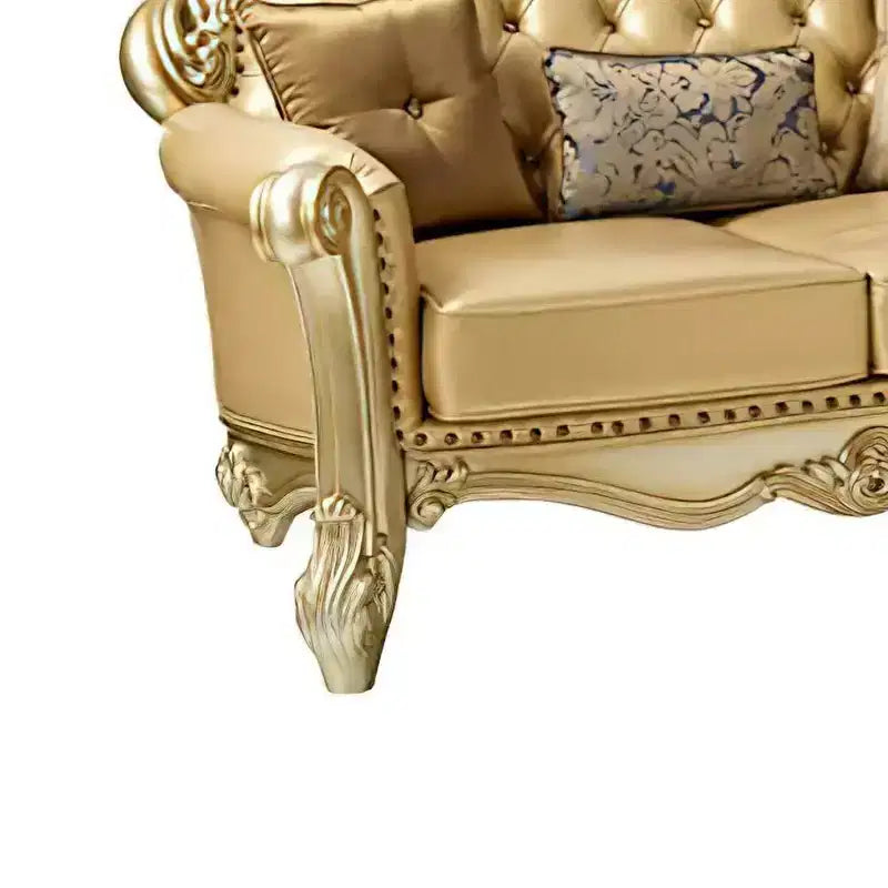 Divanetto 2 posti color osso in similpelle con patina oro, capitonné